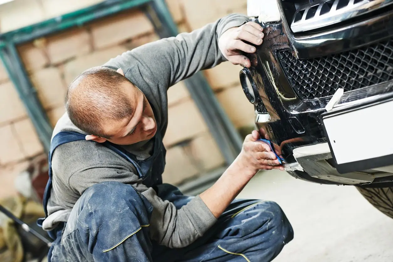 repairman working on the front car