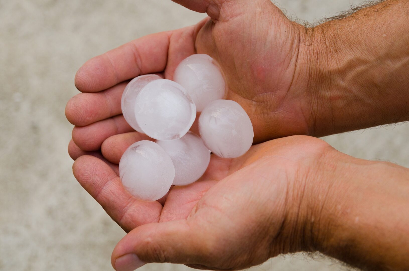 A man holding hail stones